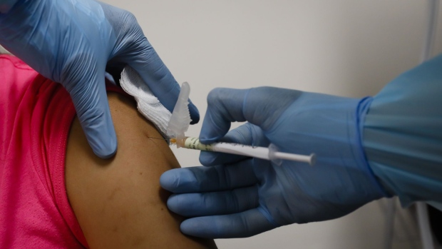 A health worker injects a woman during clinical trials for a Covid-19 vaccine at Research Centers of America in Hollywood, Florida, U.S., on Wednesday, Sept. 9, 2020. Drugmakers racing to produce Covid-19 vaccines pledged to avoid shortcuts on science as they face pressure to rush a shot to market.