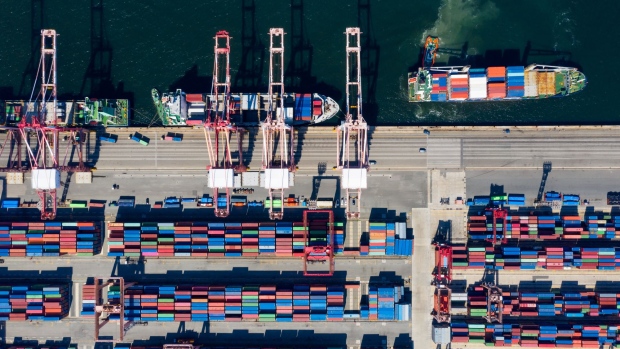 A tug boat pulls a container ship in the Busan Port Terminal (BPT) at the Port of Busan in this aerial photograph taken in Busan, South Korea, on Tuesday, July 30, 2019. A trade dispute between South Korea and Japan is threatening to spiral out of control, and both governments want the White House on their side.