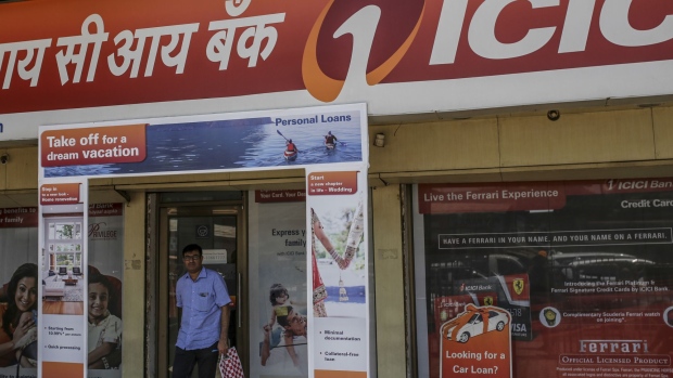 A man exits an ICICI Bank Ltd. branch in Mumbai, India, on Saturday, April 21, 2018. ICICI Bank is scheduled to announce full year earnings on May 3.