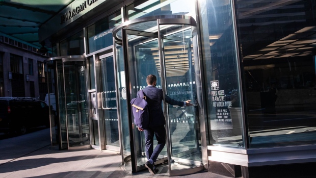 A person enters JPMorgan Chase & Co. headquarters in New York, U.S., on Monday, Sept. 21, 2020. JPMorgan CEO Dimon has made the case for a broader return, saying his firm has seen "alienation" among younger workers and that an extended stretch of working from home could bring long-term economic and social damage. Photographer: Michael Nagle/Bloomberg