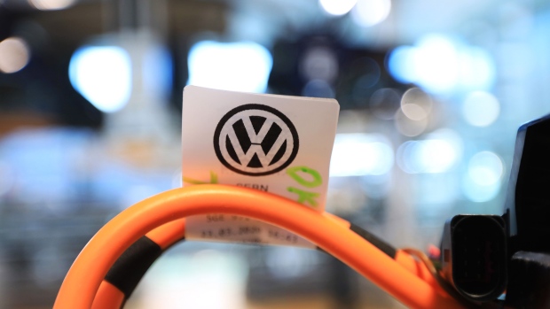 The Volkswagen AG (VW) logo sits on an electric cable manufacturing label at the Volkswagen AG e-Golf electric automobile factory in Dresden, Germany, on Friday, May 29, 2020. Even before the coronavirus crisis, automakers had to contend with an extended downturn in China, the world’s biggest auto market, where about half of all passenger electric vehicles are sold. Photographer: Krisztian Bocsi/Bloomberg