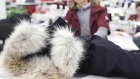 An employee checks a finished jacket with a fur collar at the new Canada Goose Inc. manufacturing facility in Montreal, Quebec, Canada, on Monday, April 29, 2019. The facility is Canada Goose's second factory in Quebec and eighth wholly-owned facility in Canada.