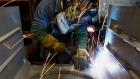 A worker uses a mig welder at a coal stove manufacturing facility in Berwick, Pennsylvania. 