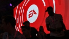 The silhouettes of attendees are seen standing in front of a Electronic Arts Inc. (EA) logo displayed on a screen during the company's EA Play event ahead of the E3 Electronic Entertainment Expo in Los Angeles, California, U.S., on Saturday, June 9, 2018. 
