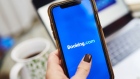 The logo for Booking Holdings Inc. is displayed on a smartphone in an arranged photograph taken in the Brooklyn borough of New York, U.S., on Sunday, May 10, 2020. In a matter of months, the coronavirus reset the clock on a decades-long aviation boom that's been one of the great cultural and economic phenomena of the postwar world. Photographer: Gabby Jones/Bloomberg
