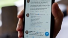 A tweet hidden with a rule-violation notice that includes the phrase "when the looting starts, the shooting starts" by U.S. President Donald Trump is displayed on a smartphone in an arranged photograph taken in Arlington, Virginia, U.S., on Friday, May 29, 2020. 