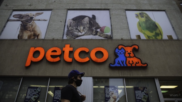A pedestrian wearing a protective mask passes in front of a Petco Animal Supplies Inc. store in New York, U.S., on Wednesday, Sept. 9, 2020. The owners of Petco Animal Supplies Inc. are exploring a sale or initial public offering that could value the retail chain at $6 billion, including debt, according to people with knowledge of the matter.