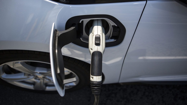 A ClipperCreek Inc. charging plug is seen connected to a General Motors Co. (GM) Chevrolet Volt electric vehicle (EV) at a charging station in Los Angeles, California, U.S., on Tuesday, July 11, 2017. City Council committee signed off financing for a program to provide more than $1.1 million in funding to add dozens of EV charging stations around the city in addition to the 560 already in place at city facilities and street locations. Photographer: Dania Maxwell/Bloomberg