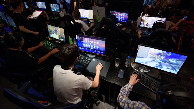 Attendees play Activision Blizzard Inc.'s Overwatch computer game at the AOC Open e-Sports event in Tokyo. Photographer: Akio Kon/Bloomberg