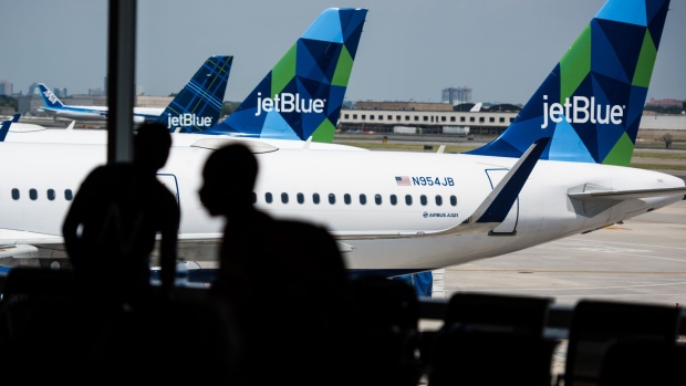 A JetBlue Airways Corp. Airbus A321 plane sits at a gate outside of Terminal 5 at John F. Kennedy International Airport (JFK) in New York, U.S., on Wednesday, July 12, 2017. Jetblue Airways Corp. is scheduled to release earnings figures on July 25.