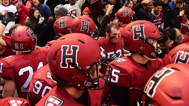 BOSTON, MA - NOVEMBER 17: Harvard Crimson celebrates a victory over the Yale Bulldogs with the student section after the game at Fenway Park on November 17, 2018 in Boston, Massachusetts. (Photo by Adam Glanzman/Getty Images)