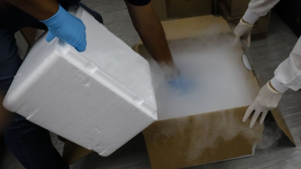 Health workers store blood samples in dry ice during clinical trials for a Covid-19 vaccine at Research Centers of America in Hollywood, Florida, U.S., on Wednesday, Sept. 9, 2020. Drugmakers racing to produce Covid-19 vaccines pledged to avoid shortcuts on science as they face pressure to rush a shot to market.