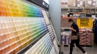 A customer wearing a protective mask walks past paints for sale at a Home Depot Inc. store in Daly City, California, U.S., on Monday, Nov. 16, 2020. 