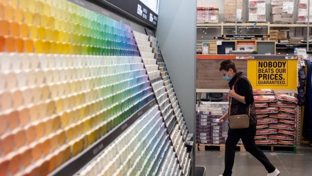 A customer wearing a protective mask walks past paints for sale at a Home Depot Inc. store in Daly City, California, U.S., on Monday, Nov. 16, 2020. 