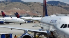 A ground crew member loads baggage on a Delta Air Lines Inc. plane at Salt Lake City International airport (SLC) in Salt Lake City, Utah.