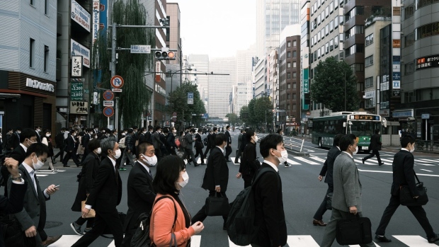 Pedestrians wearing protective masks cross a road in Shinbashi in Tokyo, Japan, on Thursday, Nov. 19, 2020. Japan's daily Covid-19 cases rose to a record of more than 2,000 on Wednesday, according to local media tallies, as the nation that had previously shown success in containing the virus now faces a rapid spread of the pathogen.