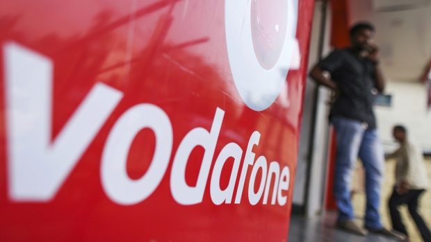 Signage for Vodafone Group Plc is displayed outside a Vodafone India Ltd. store in Mumbai. Photographer: Dhiraj Singh/Bloomberg