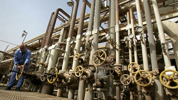 BAGHDAD, IRAQ - NOVEMBER 5: An Iraqi worker adjusts a control valves at the Daura oil refinery on November 5, 2009 in Baghdad, Iraq. Iraq and a grouping of U.S and European oil companies Exxon Mobil Corp and Royal Dutch Shell PLC signed a $50 billion contract today to develop the West Qurna oilfield, two days after the Iraqi South Oil Company signed a technical service contract with Britain's BP and China's CNPC to develop the Rumaila oilfield. The Iraqi government is trying to attract foreign investment, especially in the oil sector, in hopes of reviving its war-torn economy. Iraq has the third largest oil reserve in the world but it is producing way below its potential. (Photo by Muhannad Fala'ah/Getty Images)