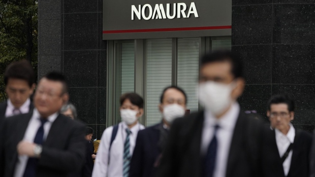 Pedestrians walk past a branch of Nomura Securities Co., a unit of Nomura Holdings Inc., in Tokyo, Japan, on Tuesday, April 23, 2019. Nomura is scheduled to release its full-year earnings on April 25. Photographer: Toru Hanai/Bloomberg