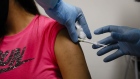A health worker injects a person during clinical trials for a Covid-19 vaccine at Research Centers of America in Hollywood, Florida, U.S., on Wednesday, Sept. 9, 2020. Drugmakers racing to produce Covid-19 vaccines pledged to avoid shortcuts on science as they face pressure to rush a shot to market.