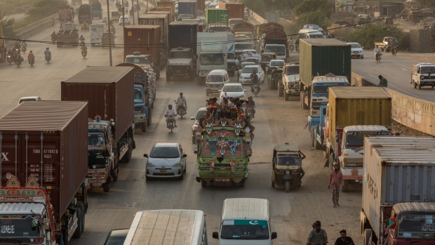 Vehicles move along a road in Karachi, Pakistan, on Friday, Oct. 16, 2020. Karachi ranks as having the worst public transport system globally, according to a 2019 study by car-parts company Mister Auto that looked at 100 major cities.