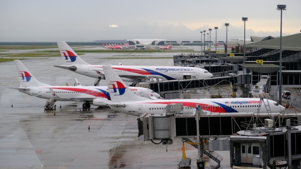 Malaysia Airlines Bhd. (MAS) aircraft stand on the tarmac at Kuala Lumpur International Airport (KLIA) during a partial lockdown imposed due to the coronavirus in Sepang, Selangor, Malaysia. on Wednesday, May 13, 2020. Malaysia has extended its relaxed lockdown by four weeks, allowing nearly all economic activities to continue while keeping its borders shut and schools closed. Photographer: Samsul Said/Bloomberg