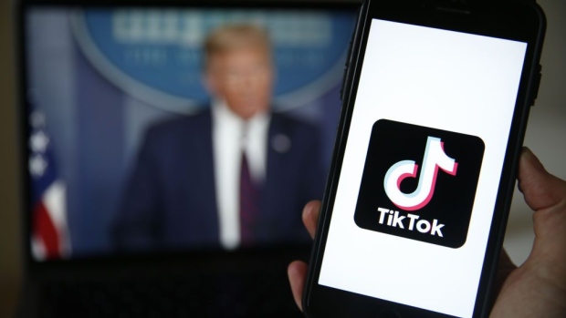 The TikTok logo is displayed in the app store in this arranged photograph in view of a video feed of U.S. President Donald Trump in London, U.K., on Monday, Aug. 3, 2020. TikTok has become a flash point among rising U.S.-China tensions in recent months as U.S. politicians raised concerns that parent company ByteDance Ltd. could be compelled to hand over American users data to Beijing or use the app to influence the 165 million Americans, and more than 2 billion users globally, who have downloaded it. Photographer: Bloomberg/Bloomberg