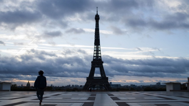 A solitary pedestrian crosses the Trocadero Square near the Eiffel Tower in Paris, France, on Monday, Nov. 2, 2020. Europe’s economic recovery is being cut short as governments implement new restrictions to fight the coronavirus that risk driving the region toward another recession. Photographer: Nathan Laine/Bloomberg