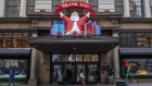 Pedestrians pass in front of a holiday Santa Claus sign outside the Macy's Inc. flagship store in the Herald Square area of New York, U.S., on Tuesday, Nov. 17, 2020. Macy's Inc. is scheduled to release earnings on November 19.