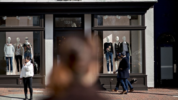 Pedestrians pass in front of an Ann Taylor Inc. Loft store in the Georgetown neighborhood of Washington, D.C., U.S., on Wednesday, Jan. 24, 2018. Workers at men's apparel stores earned an average $23.13 an hour in November, a whopping 56 percent more than the $14.81 wage at women's retailers -- a gap that's widened from less than 10 percent about two years earlier, according to Labor Department data.