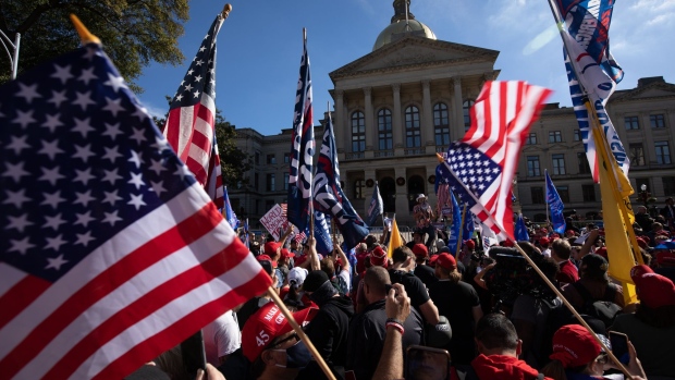 Demonstrators gather during a rally in support of President Donald Trump outside the Georgia State Capitol in Atlanta, Georgia, U.S., on Saturday, Nov. 21, 2020. Georgia Secretary of State Brad Raffensperger certified Joe Biden's win in the state Friday, a day after completing a hand audit of more than 5 million ballots, starting the clock for electors to be named and any further recount demand from Trump's campaign.