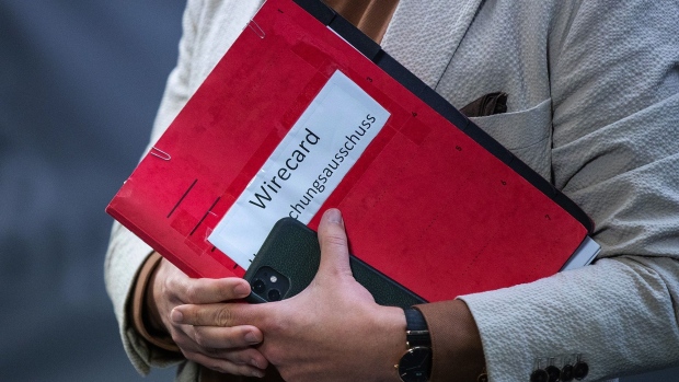 A member of the inquiry committee holds a document folder as a parliamentary probe into the collapse of Wirecard AG begins, at the Reichstag building in Berlin, Germany, on Thursday, Oct. 8, 2020. German lawmakers sought to lay some of the blame on Finance Minister Olaf Scholz for the failure to detect wrongdoing at Wirecard, as a parliamentary inquiry into the collapse of the digital-payments company gets underway in Berlin. Photographer: Krisztian Bocsi/Bloomberg