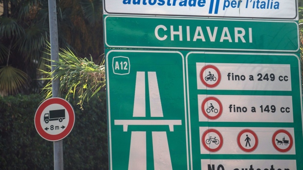 Signage indicates an upcoming toll booth on the A12 Highway operated by Autostrade per l'Italia SpA, near Genoa, Italy, on Friday, Aug. 24, 2018. Italy's Deputy Prime Minister Matteo Salvini signaled support for a political compromise taking shape following last week's Genoa bridge collapse, saying he favored a government ownership role in toll-road operator Autostrade per l’Italia, but opposed nationalizing the highway network. Photographer: Federico Bernini/Bloomberg