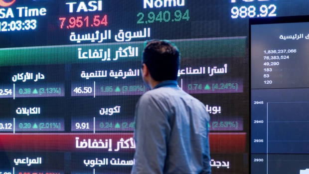 A visitor looks at stock price information displayed on a digital screen inside the Saudi Stock Exchange, also known as the Tadawul, in Riyadh, Saudi Arabia, on Tuesday, April 10, 2018. Foreign investors bought more Saudi stocks in March than ever before in anticipation of the kingdom’s upgrade to emerging-market status. Photographer: Abdulrahman Abdullah/Bloomberg