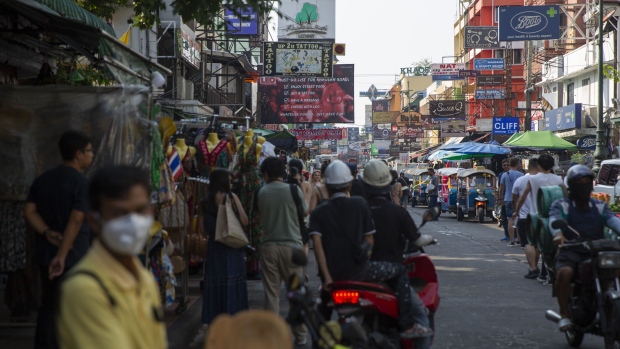 Pedestrians and motorcyclists move along Khao San Road in Bangkok, Thailand, on Wednesday, Feb. 5, 2020. The coronavirus impact is of particular concern to Thailand’s tourism industry, which makes up about 21% of the economy and has lost considerable business with the decline of travelers from China, its biggest customer base. Photographer: Andre Malerba/Bloomberg