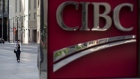 A pedestrian walks past a Canadian Imperial Bank of Commerce (CIBC) sign outside the company's headquarters in the financial district of Toronto, Ontario, Canada, on Wednesday, July 11, 2018. Canadian stocks were mixed Friday as health care tumbled and energy rose, even as was still on pace for a weekly loss amid escalating trade war risks.