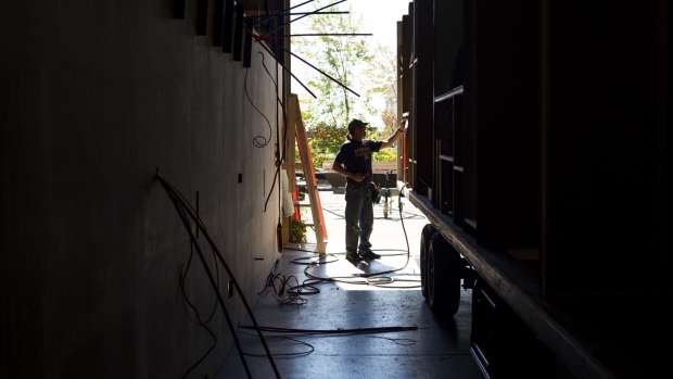 A worker installs plumbing at the HL Enterprise manufacturing facility in Elkhart, Indiana. 