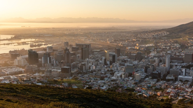 The port area stands beyond commercial high-rise properties as the sun rises in Cape Town, South Africa, on Thursday, July 23, 2020. South Africa’s surging coronavirus infections and the resumption of rolling blackouts are clouding the outlook for the economy. Photographer: Dwayne Senior/Bloomberg