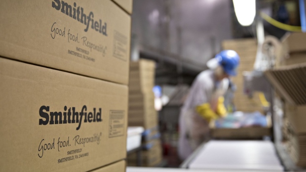 The Smithfield Foods Inc. logo is displayed on boxes at the company's pork processing facility in Milan, Missouri, U.S., on Wednesday, April 12, 2017. WH Group Ltd. acquired Virginia-based Smithfield, the world's largest pork producer, in 2013 for $6.95 billion. As Smithfield can't export sausage, ham and bacon from its U.S. factories, because China prohibits imports of processed meat, WH Group opened an 800 million-yuan ($116 million) factory in Zhengzhou that will produce 30,000 metric tons of those meats when it reaches full capacity next year. Photographer: Daniel Acker/Bloomberg