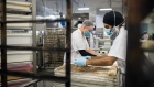 Bakers wearing protective masks shape and roll out loaves of bread dough at Portofino Bakery Ltd. in Saanichton, British Columbia, Canada, on Thursday, Nov. 19, 2020. Canadian wholesale sales rose 0.9% m/m to C$66.2B in September, according to Statistics Canada. 