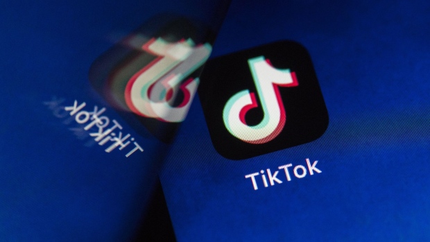 ByteDance Ltd.'s TikTok app button, reflected in a mirror, is arranged for a photograph on a smartphone in Sydney, New South Wales, Australia, on Monday, Sept. 14, 2020. Oracle Corp. is the winning bidder for a deal with TikTok’s U.S. operations, people familiar with the talks said, after main rival Microsoft Corp. announced its offer for the video app was rejected. Photographer: Brent Lewin/Bloomberg