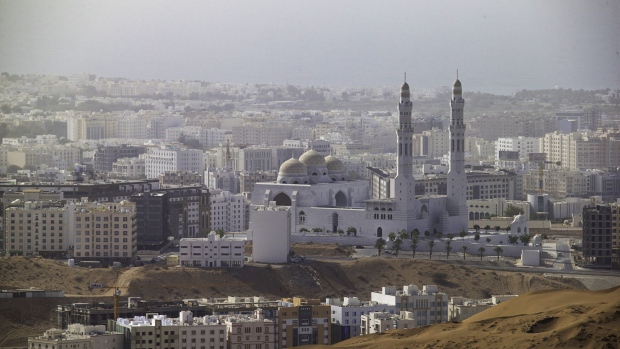 Buildings surround a mosque in Muscat, Oman, on Saturday, May 5, 2018. Being the Switzerland of the Gulf served the country well over the decades, helping the sultanate survive, thrive and make it a key conduit for trade and diplomacy in the turbulent Middle East. Photographer: Christopher Pike/Bloomberg
