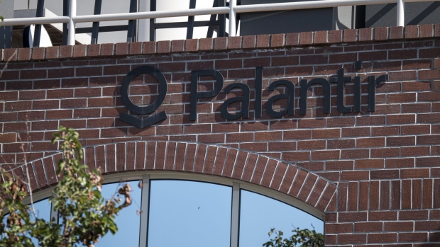 Palantir Technologies Inc. signage is displayed outside the company's headquarters in Palo Alto, California, U.S., on Tuesday, Sept. 29, 2020. Palantir, the Peter Thiel-backed data-mining startup, could have a market value of more than $20 billion when it starts trading, analysts have predicted. Photographer: David Paul Morris/Bloomberg