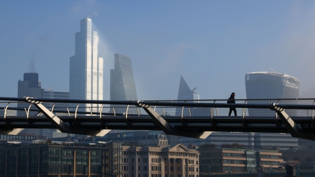 A pedestrian walks across the Millennium Bridge in London. Photographer: Simon Dawson/Bloomberg