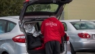A DoorDash Inc. delivery person arranges an order in the back of a vehicle outside of a DoorDash Kitchens location in Redwood City, California, U.S., on Friday, Nov. 29, 2019. Doordash, an on-demand food delivery service, unveiled their first shared commissary kitchen concept that can house up to five restaurants, offering a cost-saving alternative to traditional brick and mortar locations. Photographer: David Paul Morris/Bloomberg