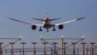 A passenger aircraft, operated by British Airways, a unit of International Consolidated Airlines Group SA (IAG) passes landing lights as it lands at London Heathrow Airport in London, U.K., on Friday, Sept. 13, 2019. Climate activists were planning to fly toy drones near Heathrow Friday as part of a campaign to draw attention to an expected increase in greenhouse gas emissions from a planned expansion of the airport.