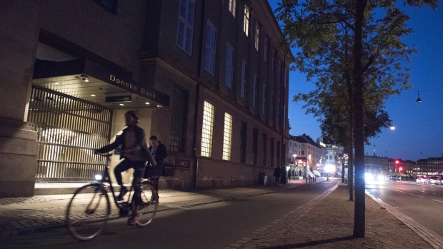 Cyclists pass an entrance to the headquarters of Danske Bank A/S in Copenhagen, Denmark, on Tuesday, Sept. 18, 2018. Danske Bank A/S Chief Executive Officer Thomas Borgen will step down amid allegations his bank was at the center of a major European money laundering scandal with as much as $234 billion flowing through a tiny unit in Estonia. Photographer: Freya Ingrid Morales/Bloomberg