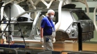 An automobile assembly line worker wears a protective face mask as Volkswagen AG (VW) restart production at their headquarter factory in Wolfsburg, Germany, on Monday, April 27, 2020. Volkswagen is restarting output at its Wolfsburg car plant, the worlds biggest, with a labor leaders warning that political fallout from the coronavirus pandemic could be more harmful than production disruptions. Photographer: Krisztian Bocsi/Bloomberg