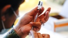 A member of the U.S. Navy prepares a dose of the Pfizer-BioNTech Covid-19 vaccine at Naval Medical Center San Diego in San Diego, California, U.S., on Tuesday, Dec. 15, 2020. The first Covid-19 vaccine shots were administered by U.S. hospitals Monday, the initial step in a historic drive to immunize millions of people as deaths surpassed the 300,000 mark. Photographer: Bing Guan/Bloomberg