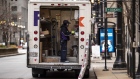 A driver for an independent contractor to FedEx Corp. wearing a protective mask unloads a Ground truck in Chicago, Illinois, U.S., on Monday, Nov. 30, 2020. Online shoppers in the U.S. are expected to drop a record-busting $12.7 billion on Cyber Monday -- the busiest e-commerce day of the year -- presenting a valuable opportunity for retailers whose websites, customer service departments and delivery operations can withstand the period of crushing traffic. Photographer: Christopher Dilts/Bloomberg